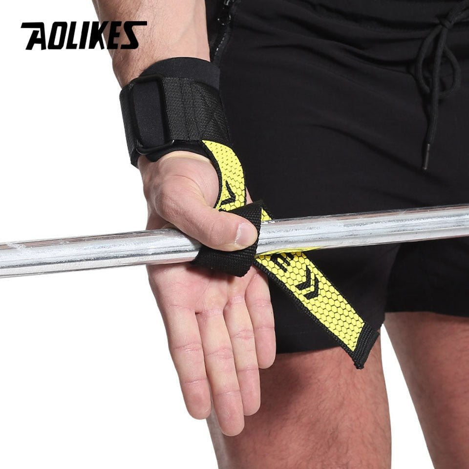 Athlete gripping barbell with yellow lifting strap
