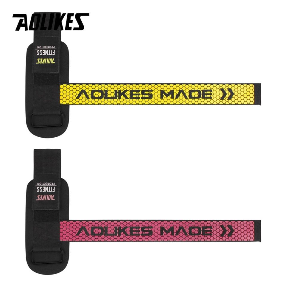 Weightlifting grip straps in yellow and pink – flat lay